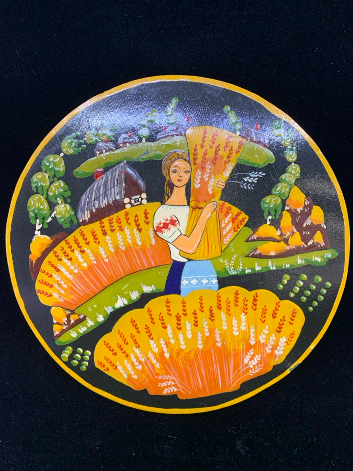 ROUND WOOD WOMAN HOLDING WHEAT WALL HANGING.
