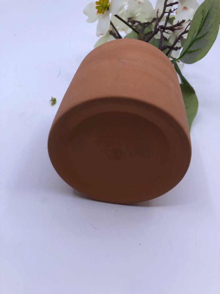 FAUX WHITE FLORAL IN TERRA COTTA PLANTER.