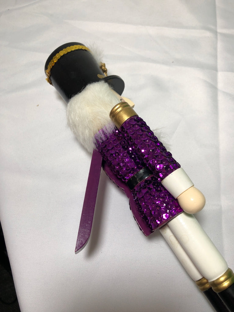 PURPLE SEQUIN NUT CRACKER.