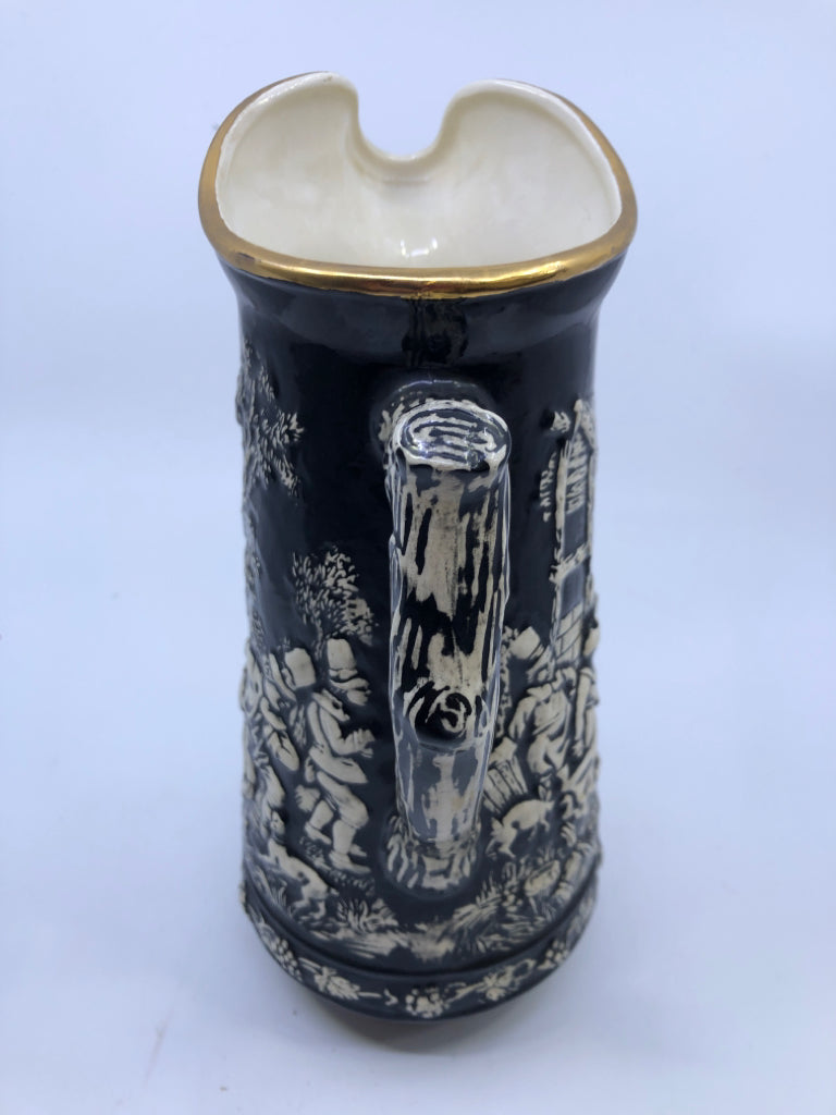 VTG BLACK W EMBOSSED PEOPLE DANCING PITCHER.