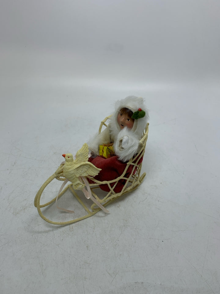 VTG BYER'S CHOICE GIRL IN SLED HOLDING PRESENT CAROLER.