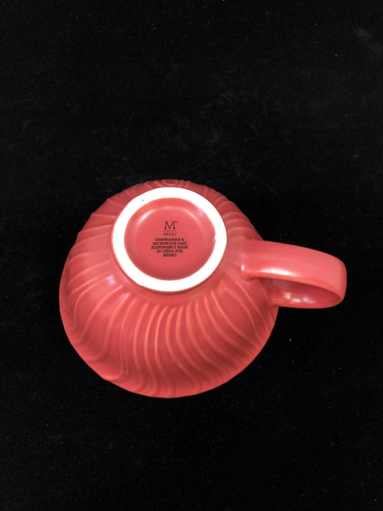 RED MUG W/FLORAL DETAILS INSIDE.