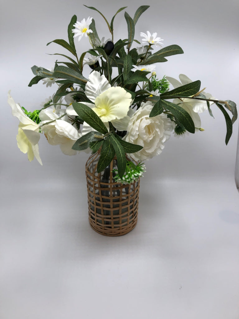 WHITE FLORALS IN COVERED WEAVE GLASS VASE.
