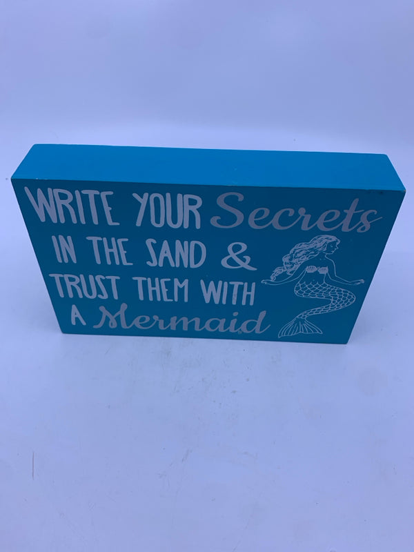 "WRITE YOUR SECRETS" WHITE WRITING BLUE BACKGROUND MERMAID ON IT.