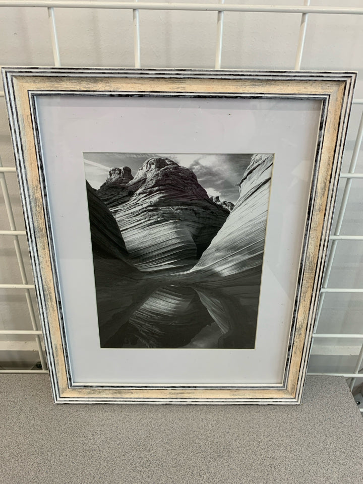 ROCK FORMATION BLACK/WHITE IN WHITE WASHED FRAME.
