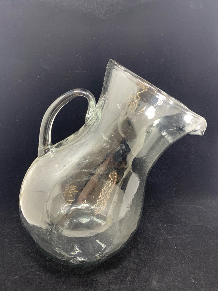 TILTED BLOWN GLASS PITCHER.