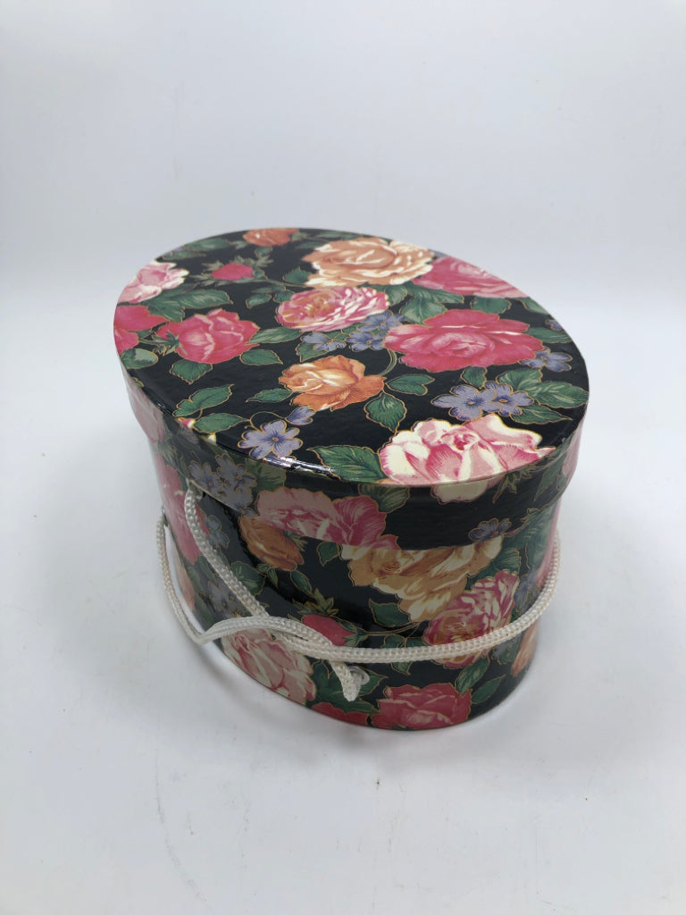 OVAL FLORAL GIFT BOX W/WHITE ROPE HANDLE.