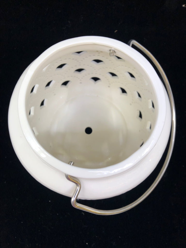 WHITE W/CUTOUTS CERAMIC CANDLE LANTERN.