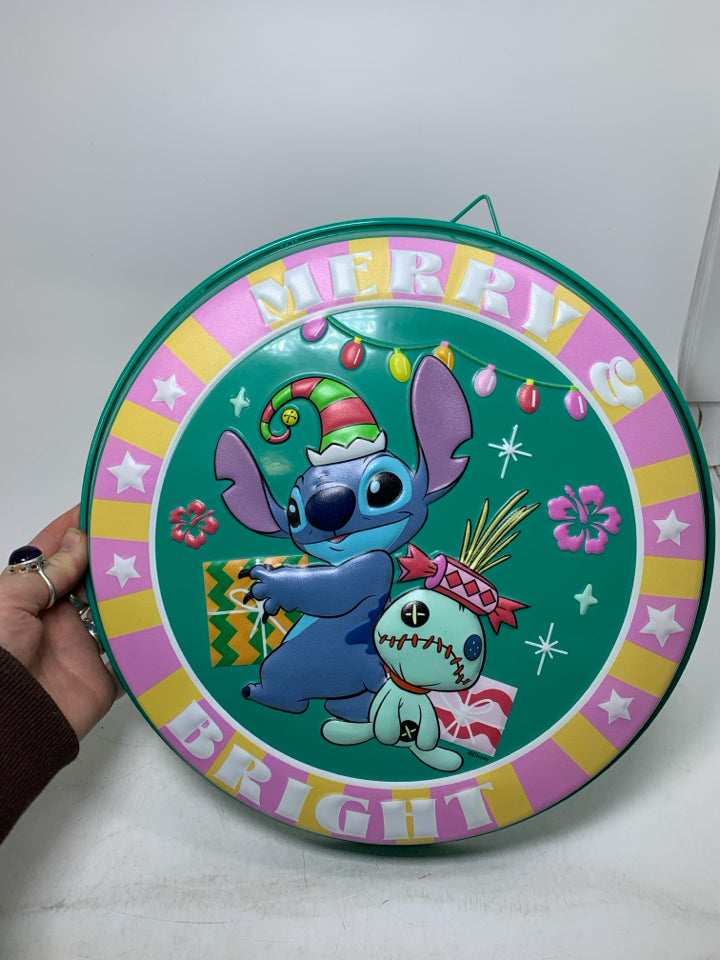 STITCH MERRY AND BRIGHT EMBOSSED METAL WALL HANGING.