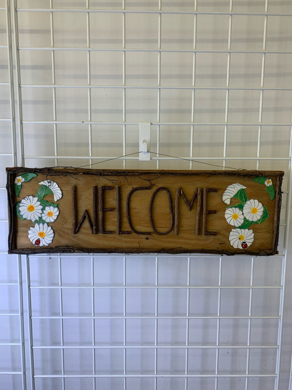WOOD "WELCOME" SIGN W/ METAL WHITE FLOWERS.