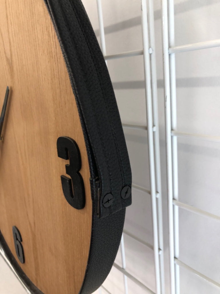 ROUND WOOD CLOCK W/FAUX LEATHER FRAME AND HANGER.