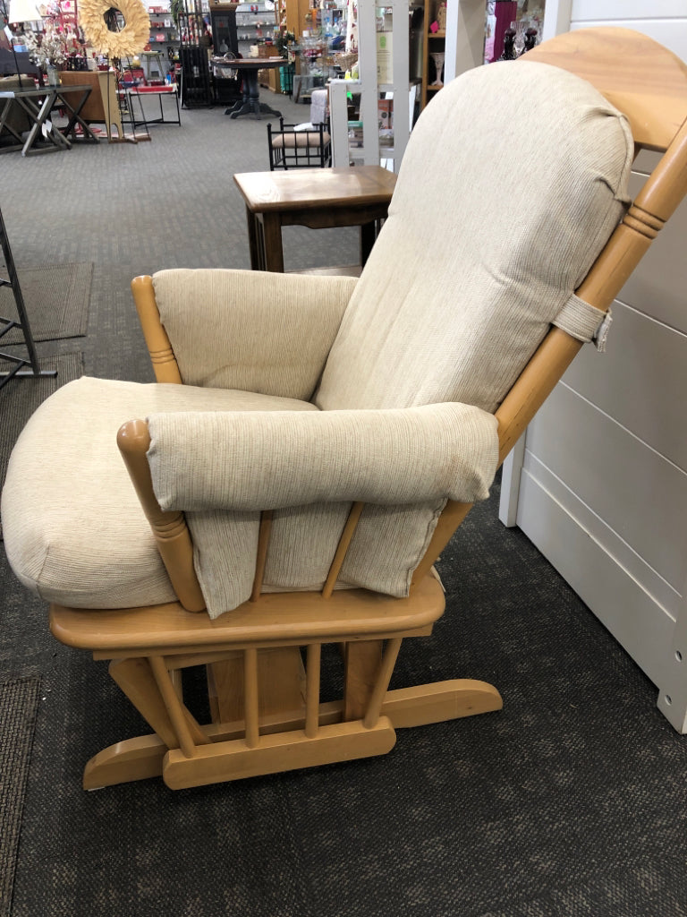 BLONDE WOODEN ROCKING CHAIR W/LEVER TO LOCK & BEIGE CUSHION.