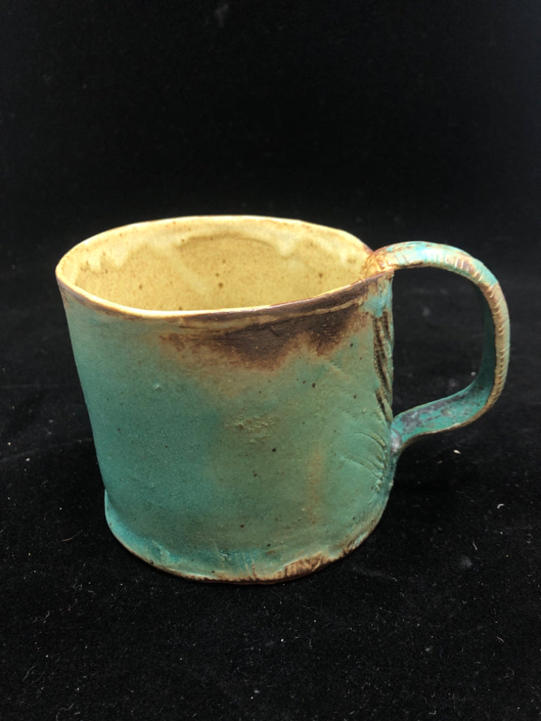 BLUE POTTERY MUG W/EMBOSSED HANDLE.
