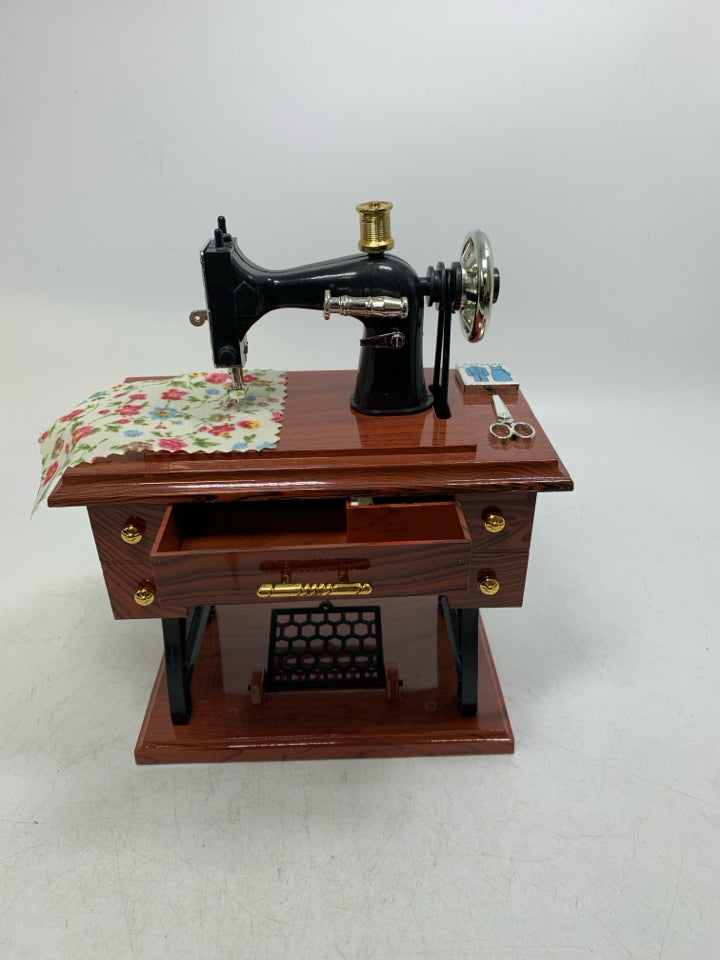 PLASTIC SEWING TABLE W/ MACHINE MUSIC BOX MOVING PIECES.