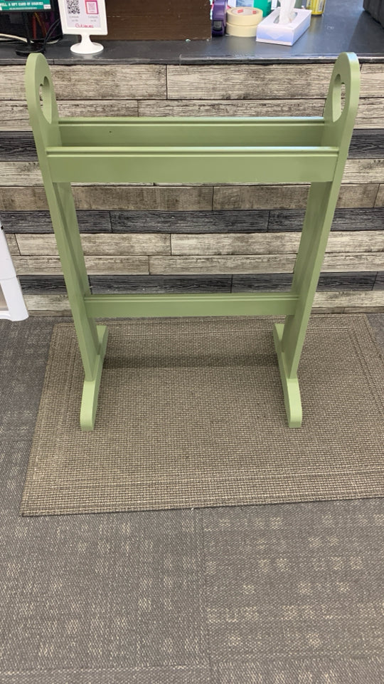GREEN PAINTED QUILT RACK W/HEART CUTOUTS.