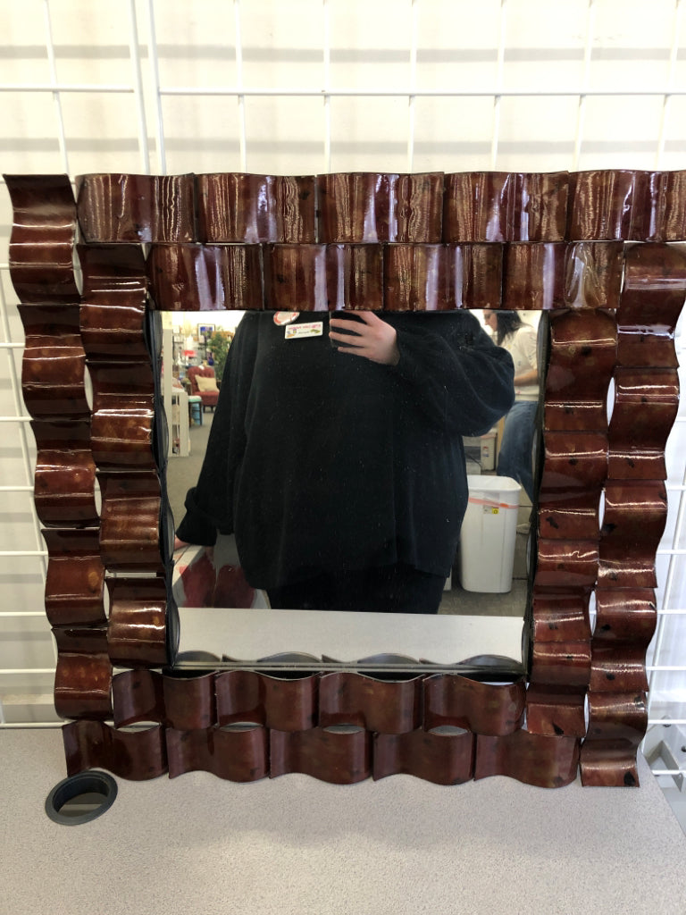 WAVY BROWN METAL FRAMED WALL MIRROR.