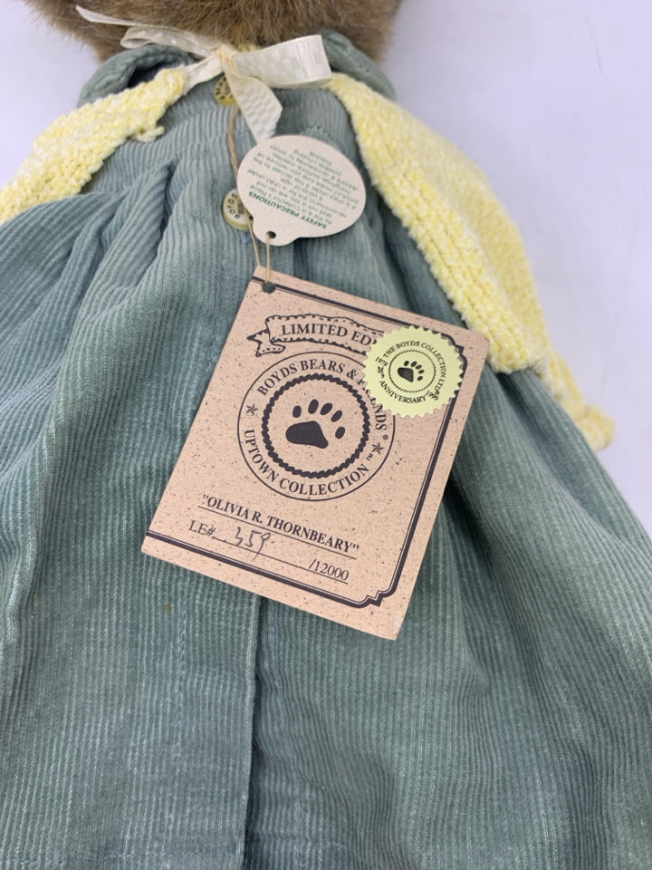 BROWN BEAR W/ LIGHT GREEN DRESS/HAT & YELLOW SHALL ON STAND BOYDS BEAR.