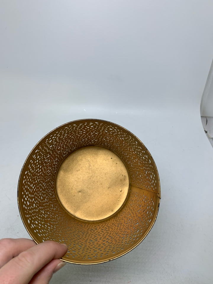 FOOTED METAL PIERCED PILLAR CANDLE HOLDER.