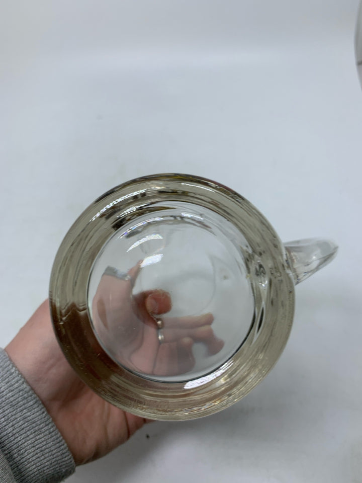 CLEAR GLASS MUG W/ PRINTED MAN ON HORSE BRUSHING IT OFF.