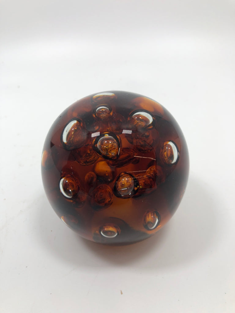 SM AMBER GLASS BUBBLE PAPER WEIGHT.