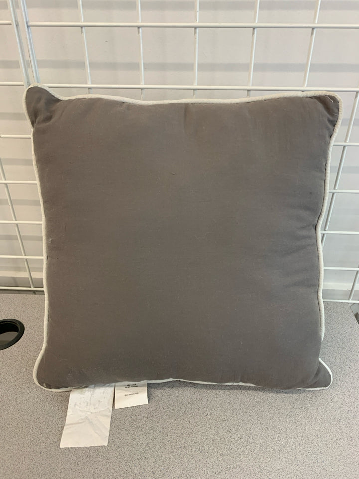 GREY RUFFLE PILLOW W/WHITE TRIM.