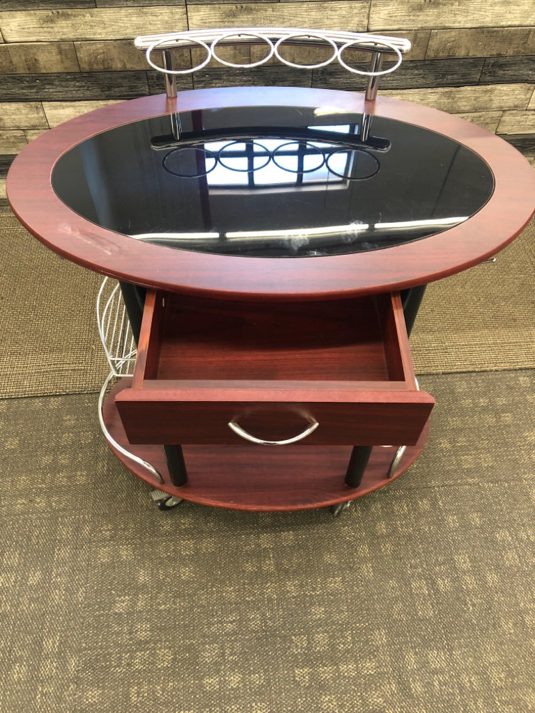 DK WOOD OVAL ROLLING BAR CART W/BLACK GLASS TOP.