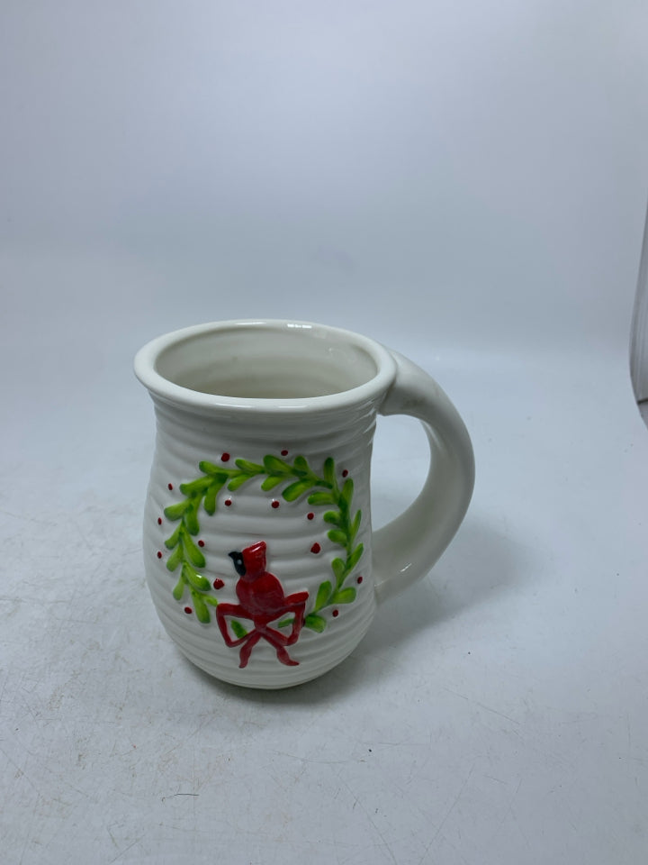 WHITE RIBBED MUG W/ CARDINAL SITTING ON WREATH.