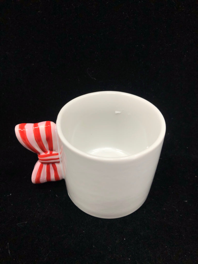 WHITE MUG W/ PINK/RED BOW HANDLE.