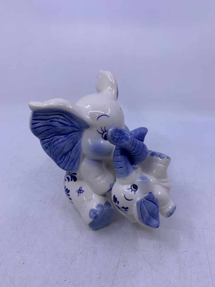BLUE/WHITE SITTING ELEPHANT W/ BABY HANGING FROM TRUNK COIN BANK.