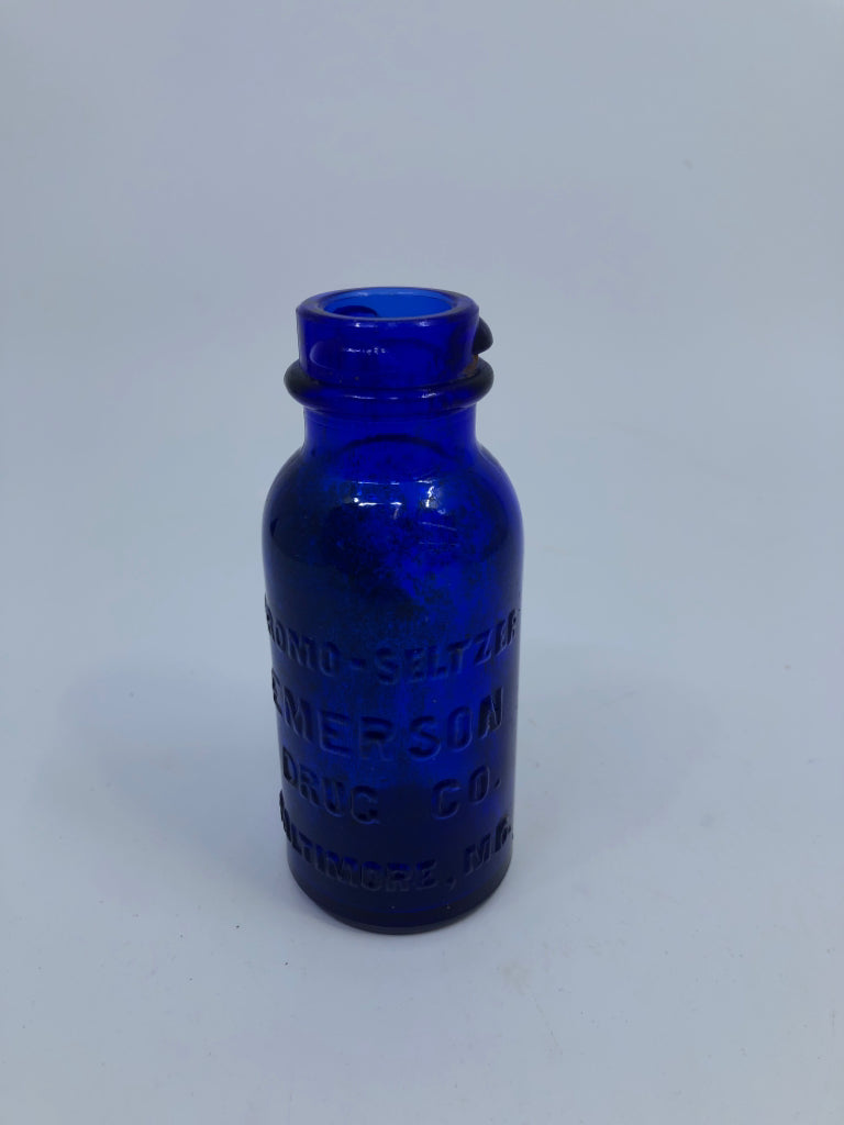 EMPTY COBALT BLUE SMALL BOTTLE W/ WRITING.