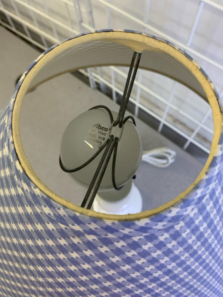 WHITE ABSTRACT BASE LAMP W BLUE AND WHITE CHECKERED SHADE.