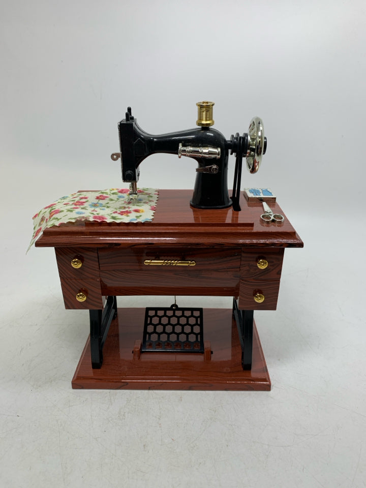 PLASTIC SEWING TABLE W/ MACHINE MUSIC BOX MOVING PIECES.