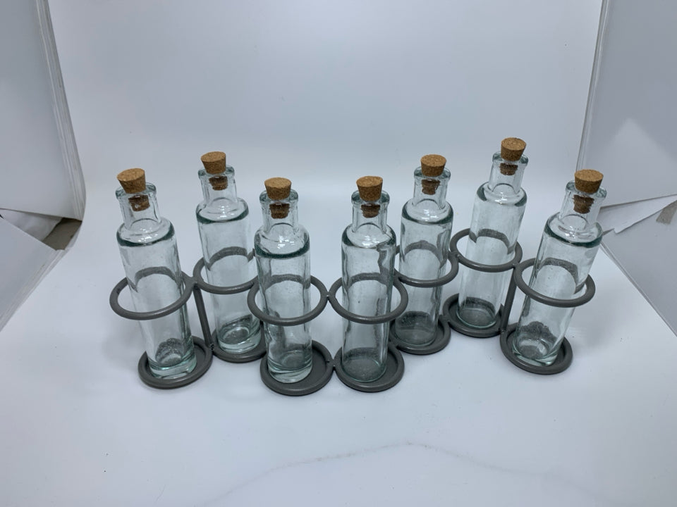 7 SLOT GREY METAL STAND W/ GLASS BOTTLES.