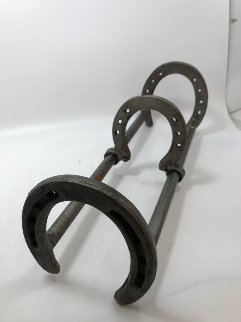 SLIDING HORSESHOE METAL BOOK HOLDER.