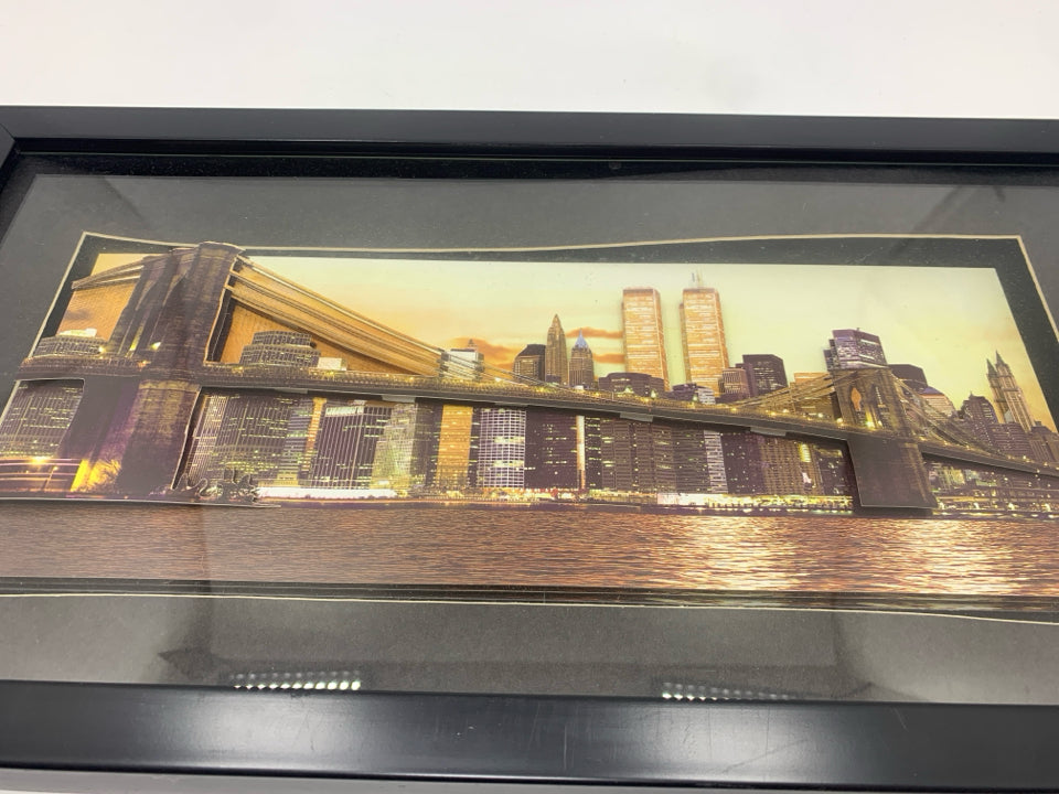 LAYERED CITY SKYLINE IN BLACK FRAME.