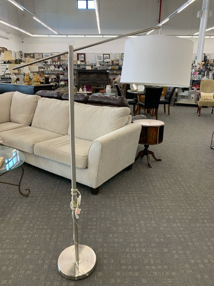 TALL SILVER FLOOR LAMP W/CREAM SHADE.