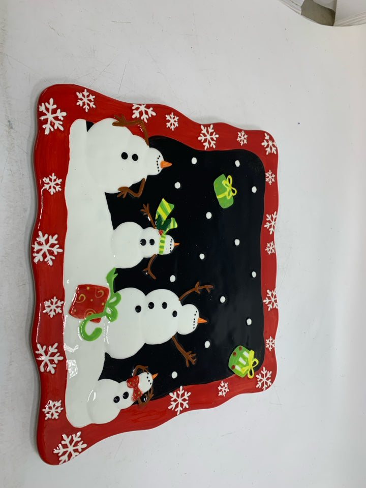 SQUARE CAKE STAND W/ EMBOSSED SNOWMEN THROWING PRESENTS IN AIR.