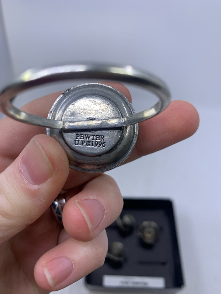 IN BOX 4 PEWTER TEACUP NAPKIN RINGS.