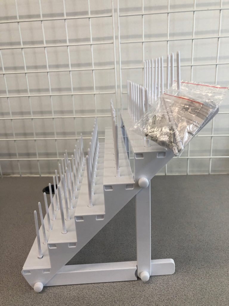 WHITE PLASTIC YARN SPOOL ORGANIZER.