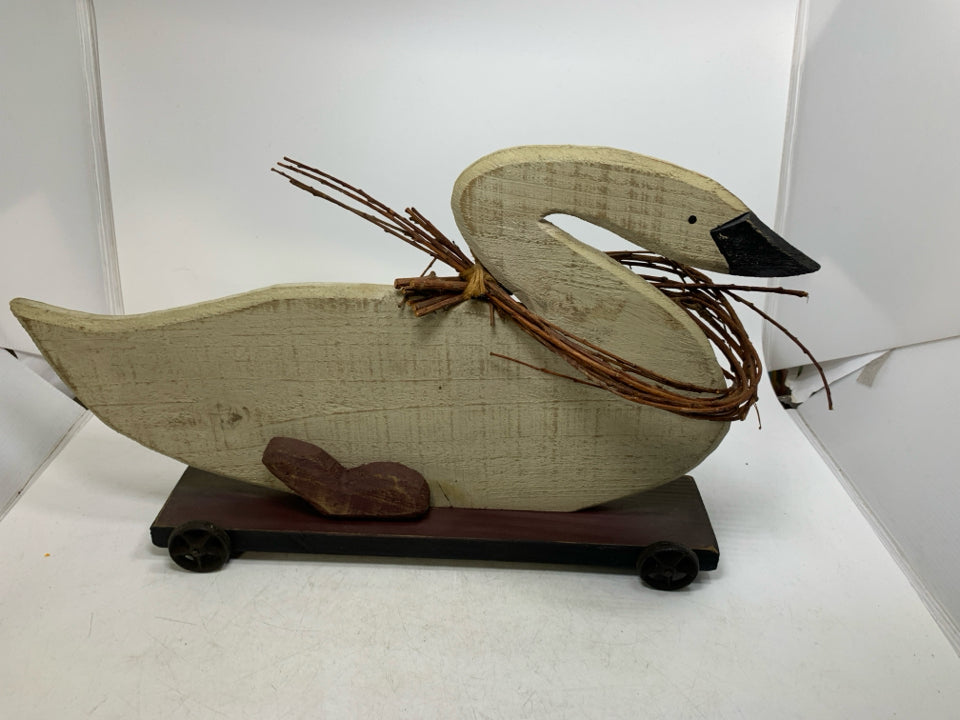 LARGE WOOD GOOSE ON WHEELS W/ TWIG GARLAND AROUND NECK.