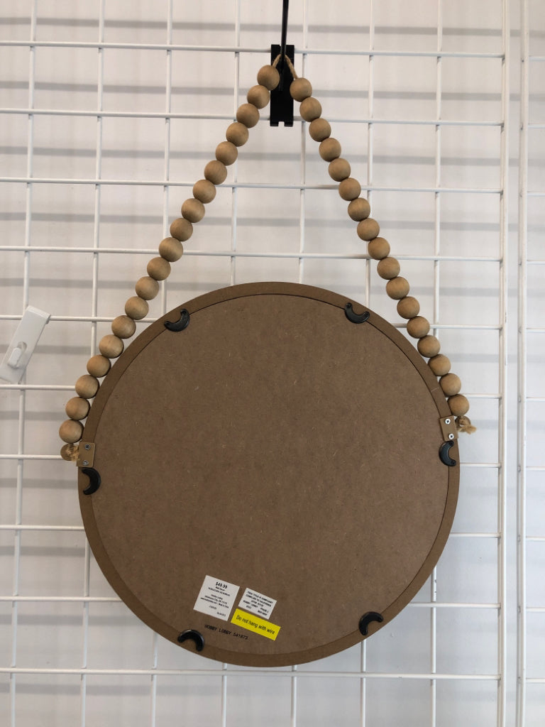 ROUND WOOD WALL MIRROR ON WOOD BEAD GARLAND.