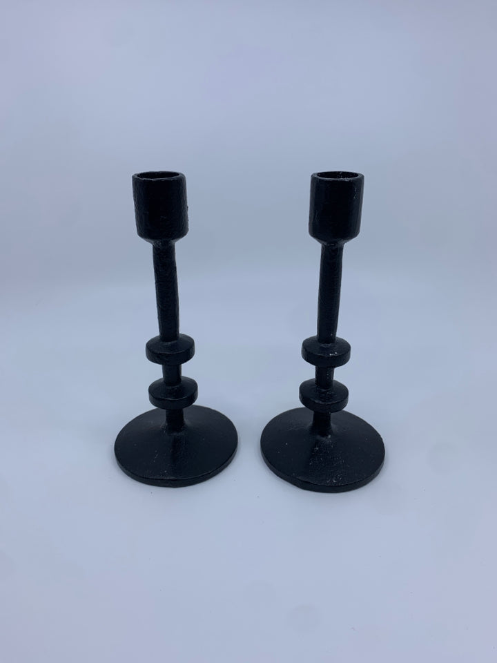 2 CAST IRON TAPER CANDLE HOLDERS.