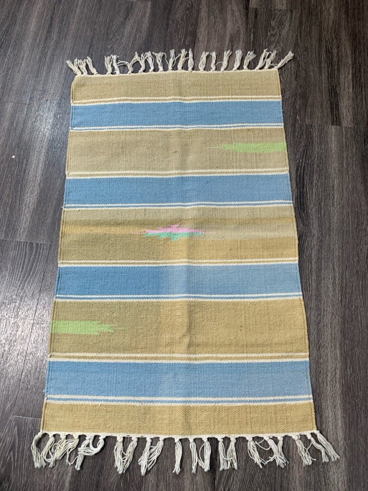 ASSORTED COLORS WOVEN AZTEC PATTERN RUG W/ TASSELS.