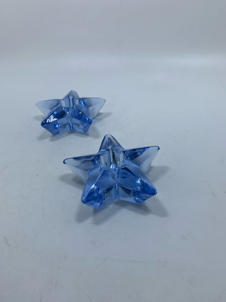 2 LIGHT BLUE STAR SHAPED GLASS TAPERED CANDLE HOLDERS.