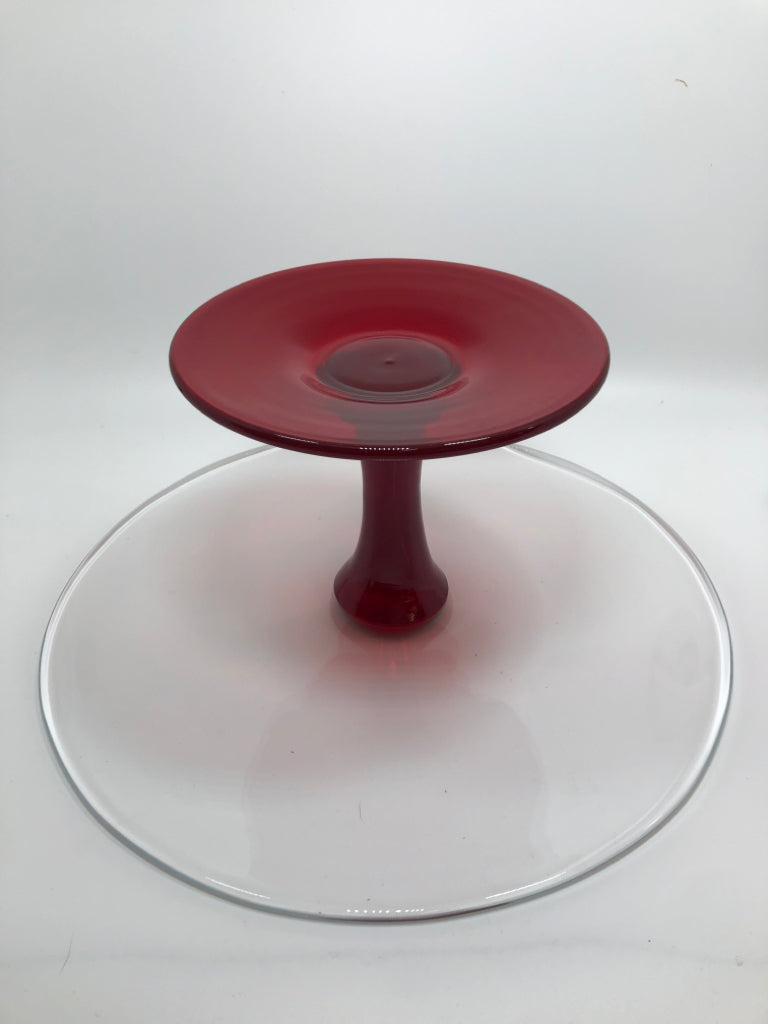 FOOTED GLASS CAKE STAND W/RED GLASS BASE.