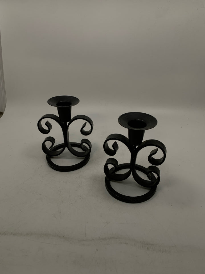 2 BLACK METAL SCROLL TAPERED CANDLE HOLDERS.