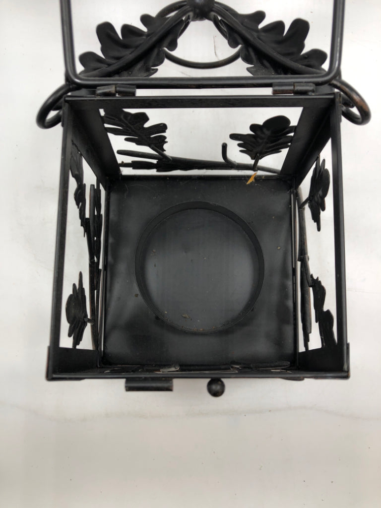 BLACK METAL LEAF EMBOSSED CANDLE LANTERN.