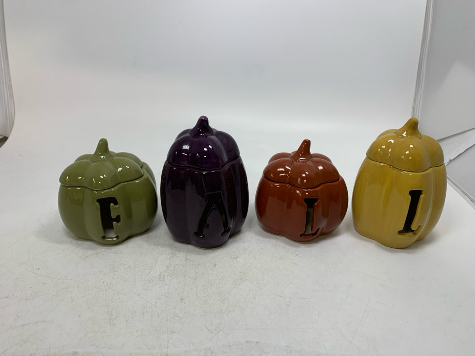 4 SMALL PUMPKIN TEA LIGHT HOLDERS SPELL OUT FALL.