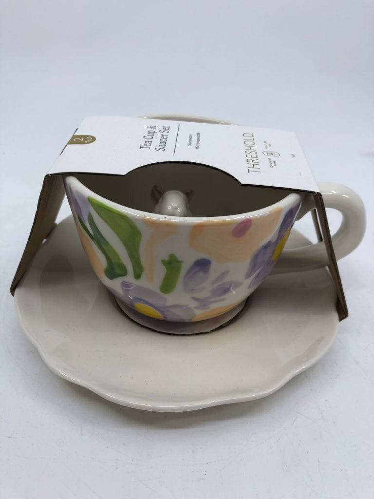 NIP TEACUP/SAUCER SET WHITE W/ PAINTED PURPLE FLOWERS RABBIT IN CENTER.