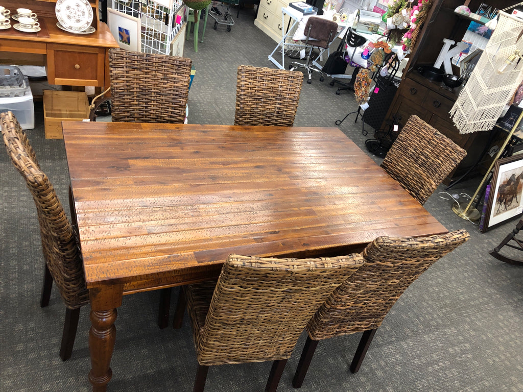 DARK WOOD STRESSED WOOD PATTERN TABLE W 6 WICKER WOVEN CHAIRS.